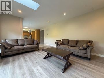 Richmond apartment for rent - A living room with a brown couch and a coffee table.