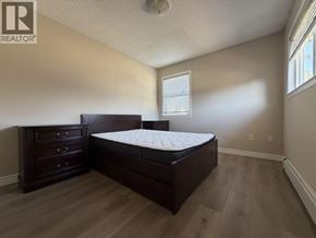 Richmond apartment for rent - A bedroom with a bed, dresser, and window.