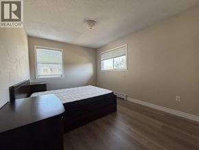 Richmond apartment for rent - A bedroom with a bed, dresser, and window.