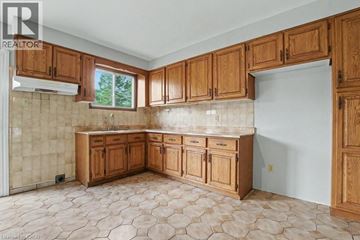 Cambridge apartment for rent - A kitchen with wooden cabinets and a tiled floor.