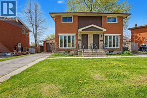 Cambridge apartment for rent - A house with a brown brick exterior and a large front yard.