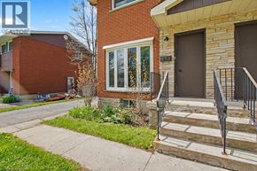Cambridge apartment for rent - A house with a brown door and a window with a view of the sky.