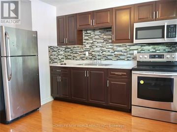 Toronto (Corso Italia-Davenport) apartment for rent - A kitchen with a refrigerator, cabinets, and a stove top oven.