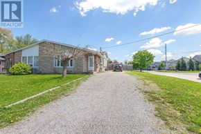 St. Catharines (Carlton/Bunting) apartment for rent - A house with a gravel driveway in front of it.