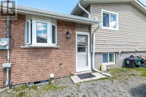St. Catharines (Carlton/Bunting) apartment for rent - A house with a brick wall and a white door.
