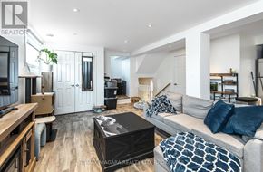 St. Catharines (Carlton/Bunting) apartment for rent - A modern living room with a grey sofa and a wooden coffee table.
