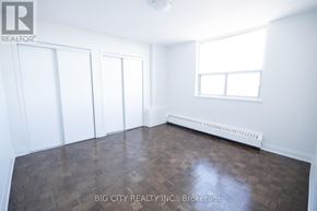 Toronto (East York) condo for rent - A room with a wood floor and white walls.