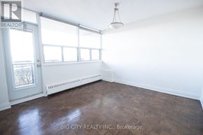 Toronto (East York) condo for rent - A room with a door, a window, and a radiator.
