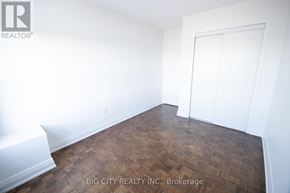 Toronto (East York) condo for rent - A room with a wooden floor and white walls.