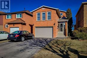 Hamilton (Stoney Creek) apartment for rent - A black car is parked in front of a red brick house.