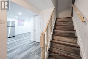 Hamilton (Stoney Creek) apartment for rent - A staircase with wooden steps and white railings.