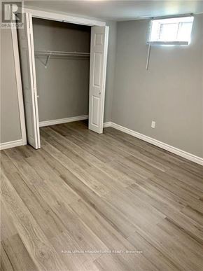 Hamilton (Berrisfield) apartment for rent - A room with a wooden floor and a white door.
