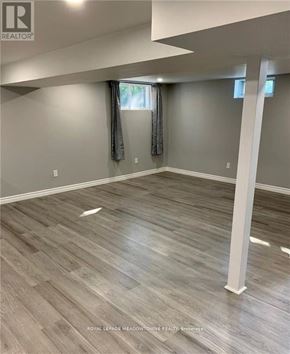 Hamilton (Berrisfield) apartment for rent - A room with wooden flooring and a window with curtains.