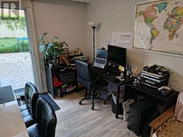 Toronto (Yorkdale-Glen Park) apartment for rent - A room with a desk, chair, and a world map on the wall.