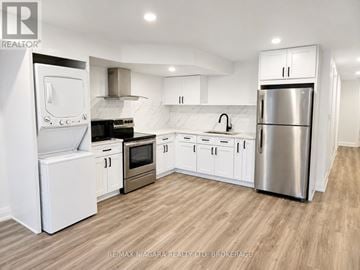 St. Catharines (Western Hill) apartment for rent - A modern kitchen with white cabinets and stainless steel appliances.