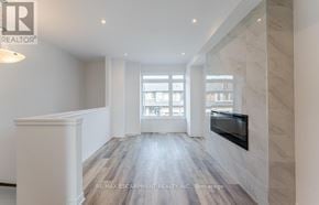 Brant (Paris) townhouse for rent - A spacious room with a fireplace and a large window.