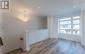 Brant (Paris) townhouse for rent - A well-lit room with a large window and wooden flooring.