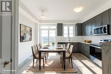 Brant (Paris) townhouse for rent - A modern kitchen with a dining table and chairs.
