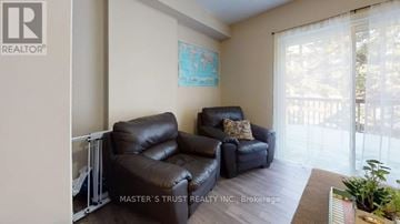 Waterloo townhouse for rent - A living room with a couch and a plant.