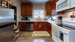 Waterloo townhouse for rent - A kitchen with wooden cabinets and a white refrigerator.