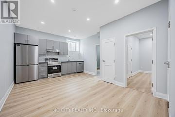 Toronto (Tam O'shanter-Sullivan) apartment for rent - A spacious kitchen with white cabinets and stainless steel appliances.