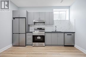 Toronto (Tam O'shanter-Sullivan) apartment for rent - A kitchen with a refrigerator, oven, and cabinets.