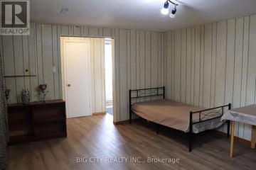 Toronto (L'amoreaux) apartment for rent - A bedroom with a bed, nightstand, and a dresser with a mirror.