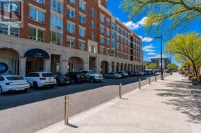 Burlington (Brant) condo for rent - A street view of a building with cars parked in front.