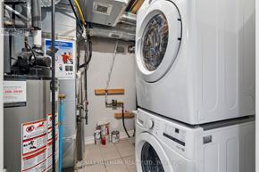 Toronto (Mimico) apartment for rent - A washing machine and dryer are stacked on top of each other in a small laundry room.