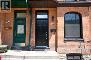 Hamilton apartment for rent - A brick house with a green door and a black door.