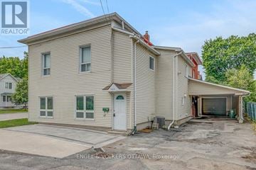Ottawa duplex for rent - A two-story house with a garage is for sale.