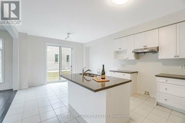 Caledon apartment for rent - A kitchen with white cabinets and a large island.