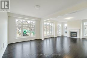 Caledon apartment for rent - A spacious living room with a fireplace and large windows.