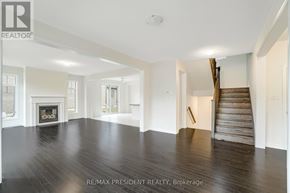 Caledon apartment for rent - A spacious room with a fireplace and wooden stairs.