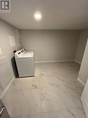 Guelph (Grange Road) condo for rent - A white room with a washer and dryer in it.