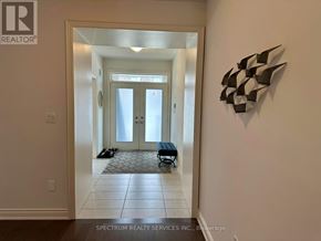 Hamilton (Waterdown) apartment for rent - A hallway with a door and a wall art.