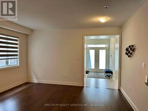 Hamilton (Waterdown) apartment for rent - A room with wooden floors and a window with blinds.