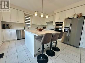 Hamilton (Waterdown) apartment for rent - A kitchen with white cabinets and a marble countertop.