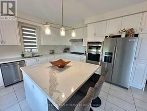 Hamilton (Waterdown) apartment for rent - A modern kitchen with a marble countertop and stainless steel appliances.