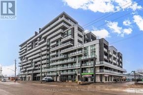 Hamilton (Lakeshore) condo for rent - A large, modern building with many windows and balconies, with the RE/MAX Escarpment Realty Inc. logo on the top left corner.