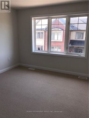 Hamilton (Meadowlands) apartment for rent - A room with a large window and a carpeted floor.