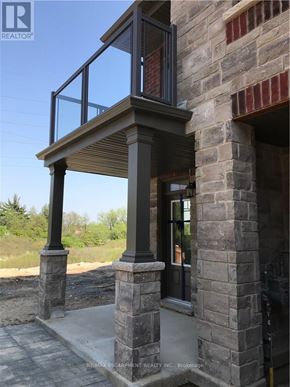 Hamilton (Meadowlands) apartment for rent - A balcony with a glass railing and stone pillars.