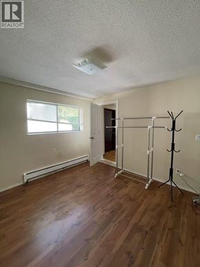 Burnaby apartment for rent - A room with wooden floors and a window.