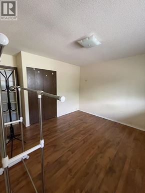 Burnaby apartment for rent - A room with wooden floors and a white ceiling with a light fixture.