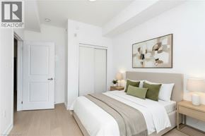 Stoney Creek condo for rent - A bedroom with a bed, nightstand, and lamp.