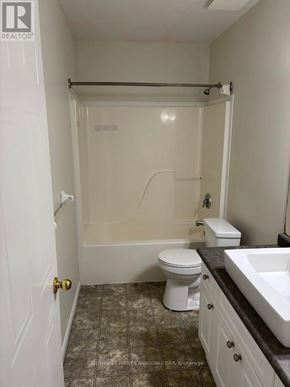 London East (East P) apartment for rent - A white bathroom with a toilet, sink, and bathtub.
