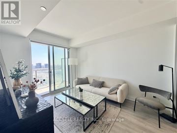 Vaughan (Vaughan Corporate Centre) condo for rent - A living room with a glass table and a couch.
