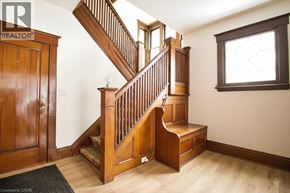 Hamilton apartment for rent - A wooden staircase with a window to the right.