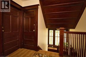 Hamilton apartment for rent - A wooden door with a glass window is in the hallway.
