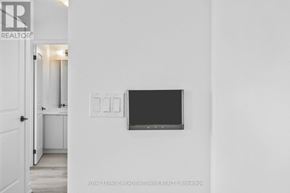 Burlington (Brant) condo for rent - A white room with a flat screen TV mounted on the wall.